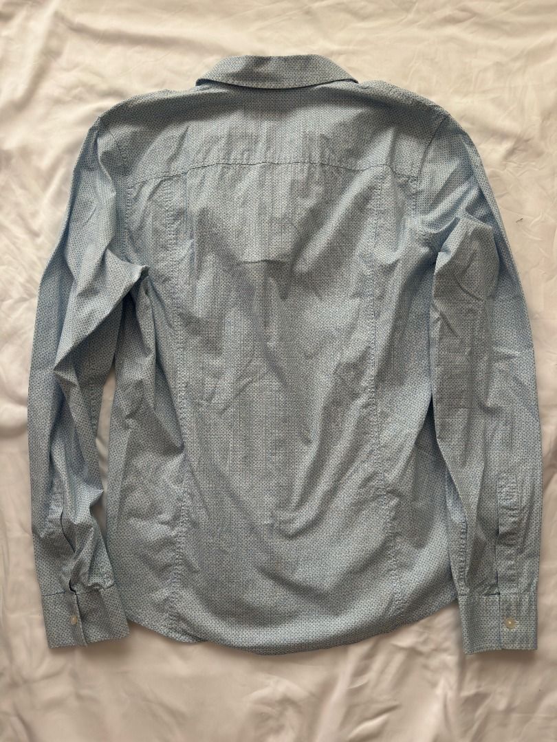 Calvin Klein Jeans Light Blue Patterned Long Sleeve Shirt Large (Category: Longsleeves) located in Cebu City. Submitted by _t.rix (Listing ID 1470382931, Image 2). Description: - Brand: Calvin Klein Jeans - Color: Light blue with subtle geometric micro-print - Style: Long sleeves, classic collar, front button closure - Details: Small black logo tag near the bottom hem - Fit: Standard fit - Versatility: Great for casual wear or dressing up.