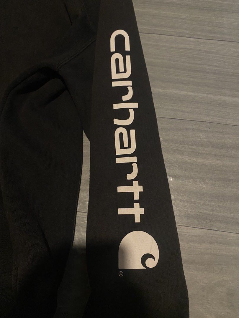 Carhartt Hoodie (Category: Coats, Jackets and Outerwear) located in Talavera. Submitted by adrnvault (Listing ID 1470469716, Image 3). Description: Carhartt Midweight Sleeve Logo Hoodie Issue: minimal disco as workgear Size: large Color rate: 8/10 Color: black Width: 25 Length: 29.