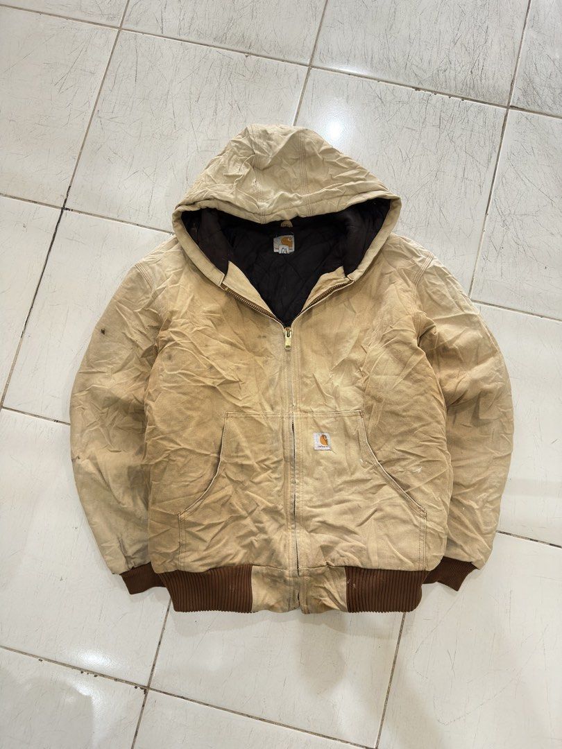 Carhartt Quilted Flannel Lined Duck Active Jacket Tan XL (Category: Coats, Jackets and Outerwear) located in Cavite. Submitted by remcadzzz (Listing ID 1470427199, Image 1). Description: - Brand: Carhartt - Style: Active Jacket - Color: Tan / Duck Canvas - Size: XL - Origin: Made in USA tag present - Features: Quilted warm lining, attached hood, front pouch pockets, ribbed cuffs & hem, heavy-duty brass zipper - Condition: Shows natural wear and v