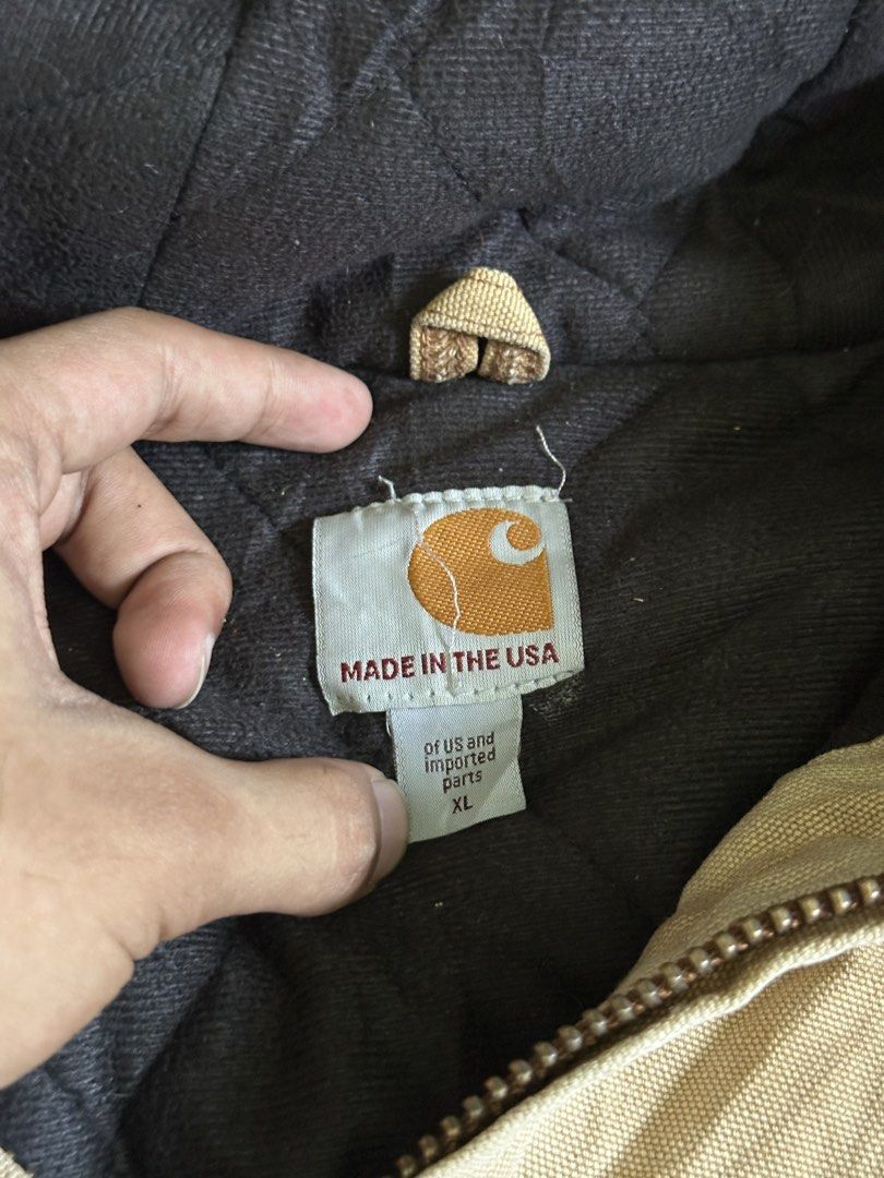 Carhartt Quilted Flannel Lined Duck Active Jacket Tan XL (Category: Coats, Jackets and Outerwear) located in Cavite. Submitted by remcadzzz (Listing ID 1470427199, Image 3). Description: - Brand: Carhartt - Style: Active Jacket - Color: Tan / Duck Canvas - Size: XL - Origin: Made in USA tag present - Features: Quilted warm lining, attached hood, front pouch pockets, ribbed cuffs & hem, heavy-duty brass zipper - Condition: Shows natural wear and v