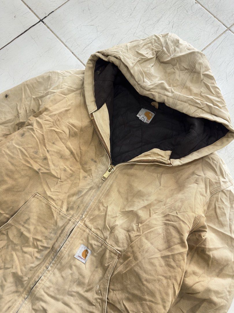 Carhartt Quilted Flannel Lined Duck Active Jacket Tan XL (Category: Coats, Jackets and Outerwear) located in Cavite. Submitted by remcadzzz (Listing ID 1470427199, Image 2). Description: - Brand: Carhartt - Style: Active Jacket - Color: Tan / Duck Canvas - Size: XL - Origin: Made in USA tag present - Features: Quilted warm lining, attached hood, front pouch pockets, ribbed cuffs & hem, heavy-duty brass zipper - Condition: Shows natural wear and v