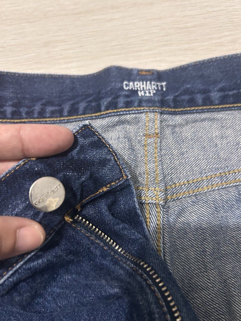 Carhartt WIP Denim Jeans (Category: Jeans) located in Bulacan. Submitted by friitzie (Listing ID 1470401766, Image 3). Description: - Brand: Carhartt WIP - Color: Dark blue - Closure: Button fly with branded hardware - Design: Classic five-pocket styling with rear logo patch - Bought in the US - Quality: Durable fabric and classic workwear construction - Condition: Clean look that pairs with any outfit.