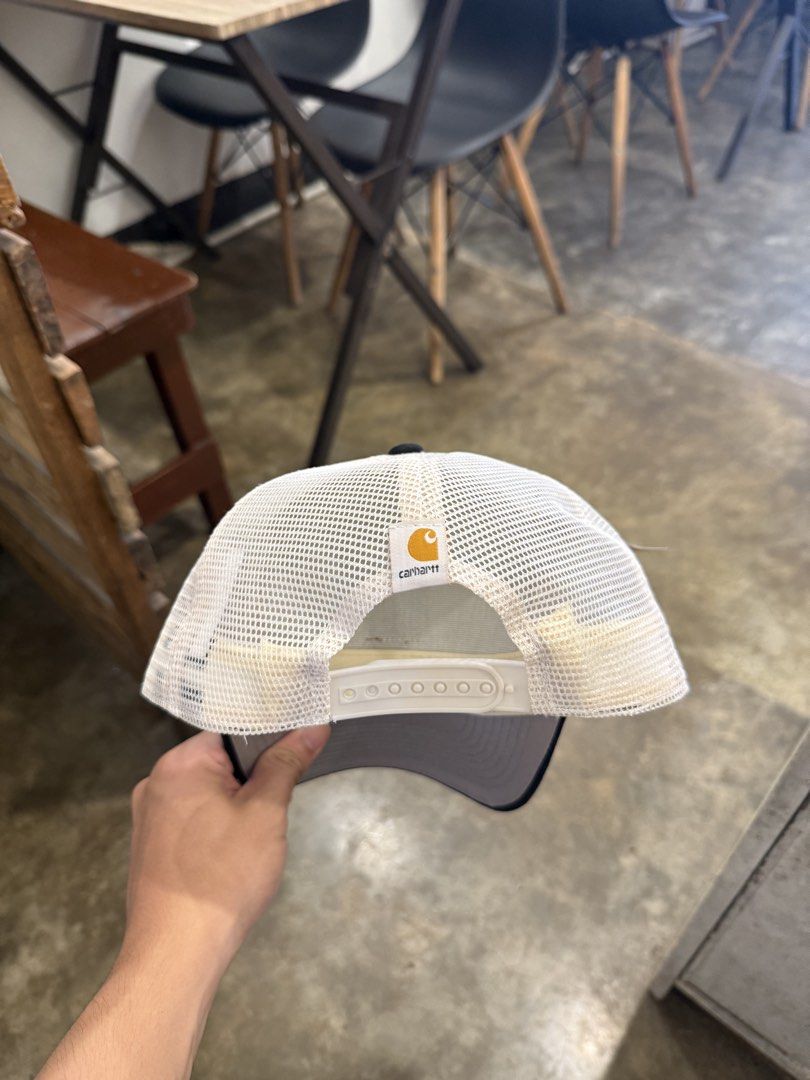 Carhartt Trucker Hat Off White Black Snapback (Category: Caps & Hats) located in Pozorrubio. Submitted by kulin_ (Listing ID 1470495800, Image 2). Description: - Brand: Carhartt - Condition: Brand new with original tag attached - Color: Off-white and black - Design: Structured front with a curved brim and breathable mesh back panels - Details: Classic brown leather Carhartt logo patch on the front - Fit: Adjustable white snapback closure.