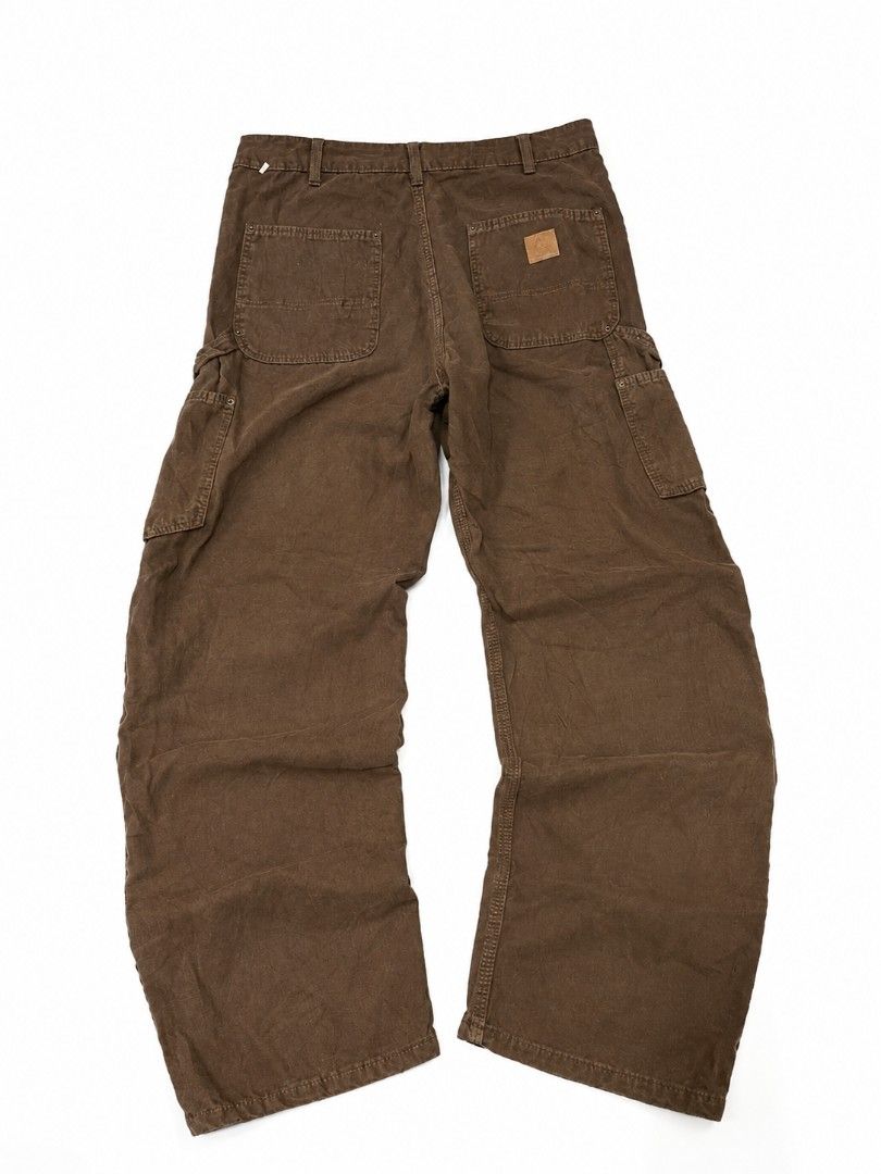 Carpenter pants Work Pants (Category: Jeans) located in Urdaneta. Submitted by goldeneagle-e662 (Listing ID 1470474027, Image 1). Description: - Brand: Carhartt - Style: Double-knee carpenter pants / Workwear - Color: Versatile brown - Material: Rugged, durable cotton duck fabric - Fit: Straight relaxed fit through the leg - Features: Hammer loop, side utility pockets, and back patch pockets - Details: Iconic woven Carhartt logo patch on the back