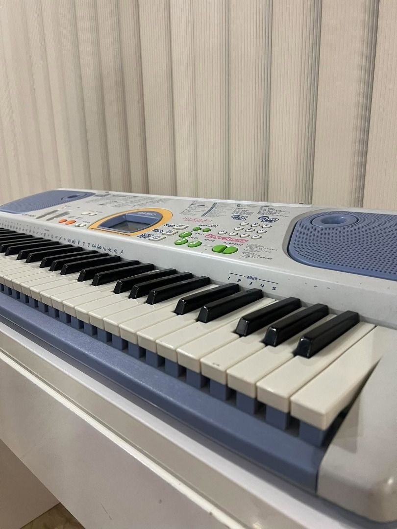 Casio LK-101 Electronic Keyboard (Category: Musical Instruments) located in San Fernando. Submitted by rickcaya (Listing ID 1470379227, Image 3). Description: - Model: Casio LK-101 electronic keyboard (Silver & Blue) - Keys: 61 keys with built-in speakers and LCD screen - Condition: Clean, all buttons and keys intact and working - Features: Built-in teaching functions ideal for kids and beginners - Power: Runs on AC power adapter or batteries for