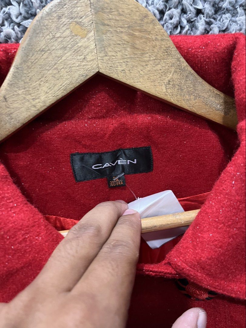 CAVEN double-breasted coat | Size M (Category: Coats, Jackets and Outerwear) located in General Trias. Submitted by zrchustle.604 (Listing ID 1470457749, Image 3). Description: vibrant red, double-breasted coat branded by CAVEN. It features structured lapels, distinct custom-designed black and red accent buttons, a matching waist tab detailing, and a slight A-line flare toward the hemline..