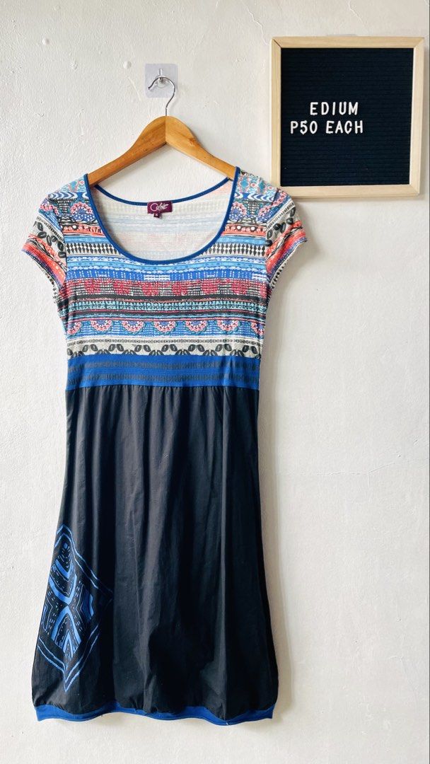 Celine boho patterned dress (Category: Dresses) located in Caloocan City. Submitted by lovemyclothes21 (Listing ID 1470374363, Image 1). Description: - Brand: Celine - Size: S (tag at inner collar) - Design: Patterned top with a black skirt section and blue tribal graphic print near the hem - Style: Short sleeves, round neckline - Condition: Great casual piece for daily wear - Fabric: Comfortable and easy to wear.