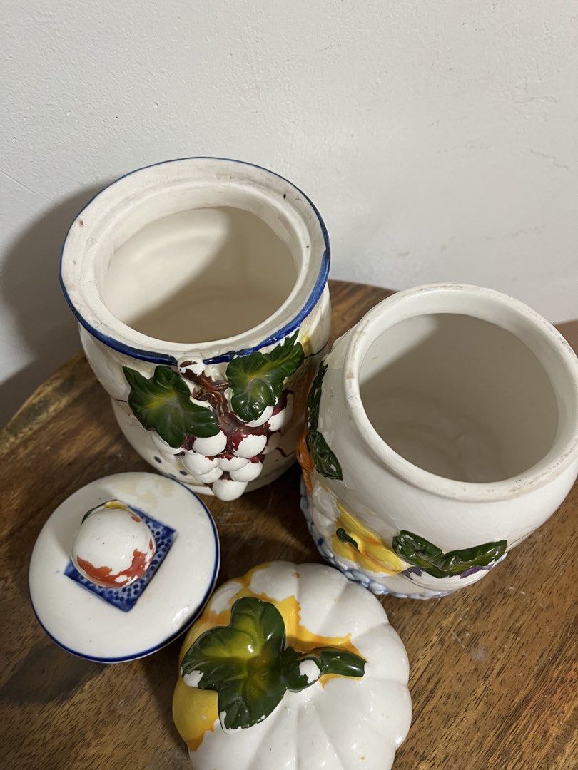 Ceramic Fruit and Vegetable Kitchen Canister Set (Category: Food Organization & Storage) located in Cabuyao City. Submitted by rdtrmt (Listing ID 1470480327, Image 3). Description: - Set of two charming ceramic storage jars with removable lids along with three small ceramic teapots - Jar 1 features playful 3D grapes with leaves and blue polka dots - Jar 2 showcases hand-painted pumpkins, carrots, and a delicate blue floral trim - The small teapot