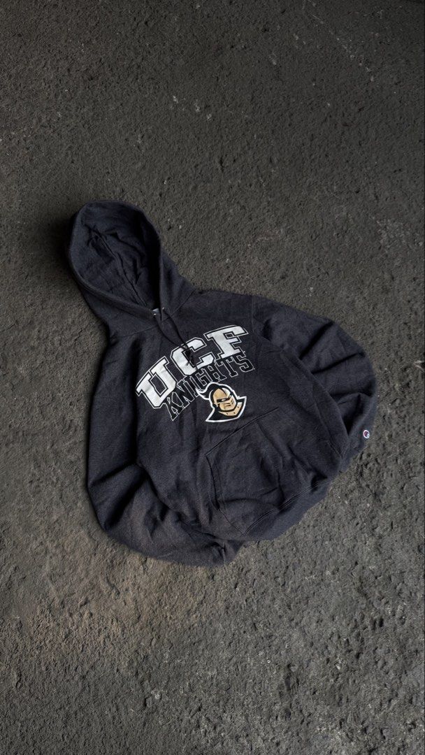 Champion UCF Knights pullover fleece hoodie (Category: Coats, Jackets and Outerwear) located in Teresa. Submitted by boanerjes (Listing ID 1470526791, Image 1). Description: Champion UCF Knights pullover fleece hoodie featuring the white “UCF Knights” lettering and knight helmet graphic on the chest 20x25.