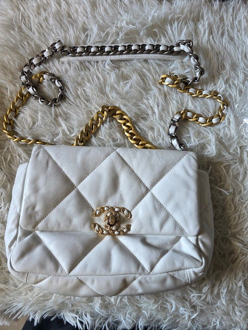 Chanel 19 Flap Bag White Quilted Leather (Category: Cross-body Bags) located in Lemery. Submitted by venus23 (Listing ID 1470363038, Image 2). Description: - Chanel 19 Flap Bag in timeless white quilted leather - Features striking mixed metal hardware in gold and ruthenium - Designed with a leather-woven chain strap and iconic CC turn-lock closure - Comes from a trusted Carousell seller – buy with confidence! - Send a message for inquiries or add