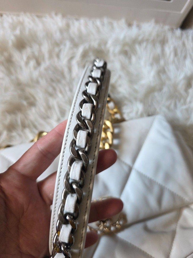 Chanel 19 Flap Bag White Quilted Leather (Category: Cross-body Bags) located in Lemery. Submitted by venus23 (Listing ID 1470363038, Image 3). Description: - Chanel 19 Flap Bag in timeless white quilted leather - Features striking mixed metal hardware in gold and ruthenium - Designed with a leather-woven chain strap and iconic CC turn-lock closure - Comes from a trusted Carousell seller – buy with confidence! - Send a message for inquiries or add