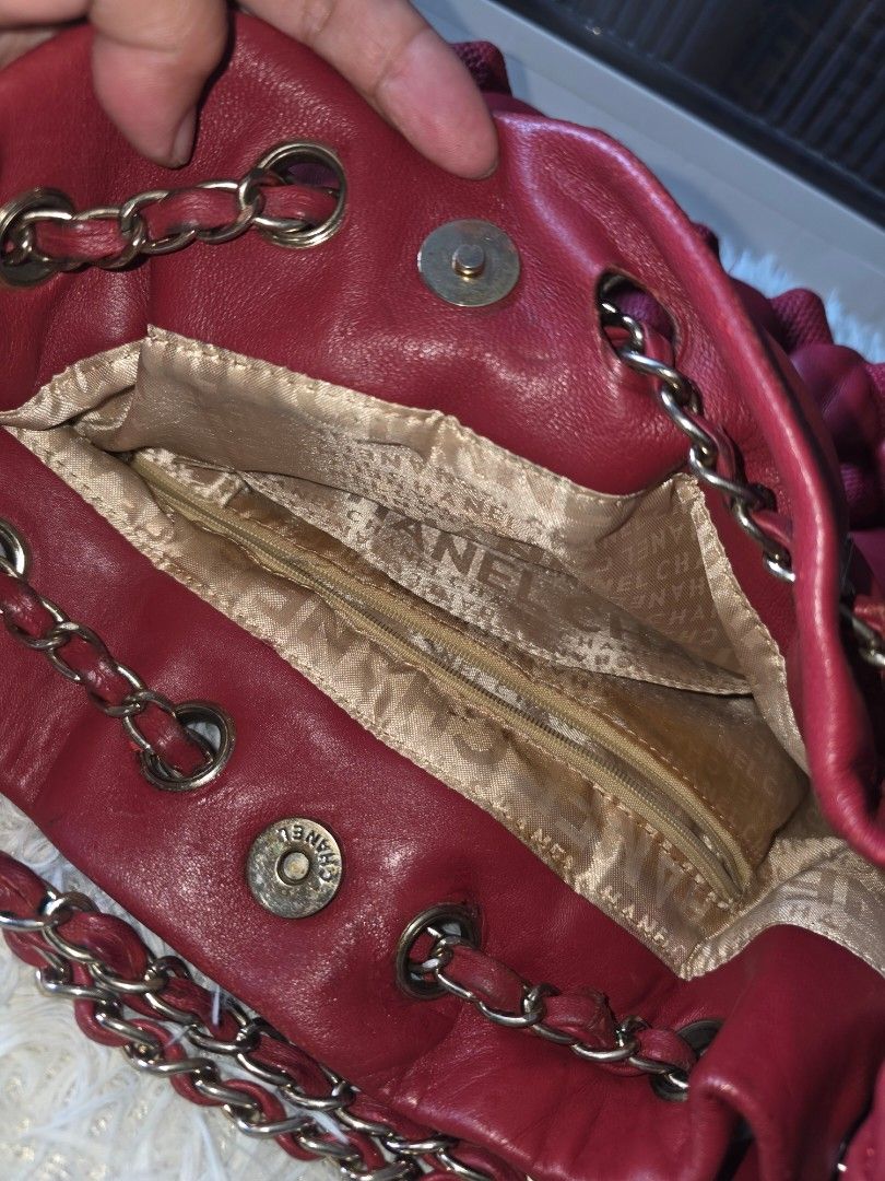 Chanel Quilted Red Leather Handbag with Chain Strap (Category: Shoulder Bags) located in Lemery. Submitted by venus23 (Listing ID 1470371751, Image 3). Description: - red leather handbag with a chic puffy quilted texture - Silver chain straps threaded with matching red leather - Iconic CC logo charm hanging from the top - Gold fabric interior lining featuring Chanel lettering throughout - Practical zippered inner pocket, interior brand tag, and a