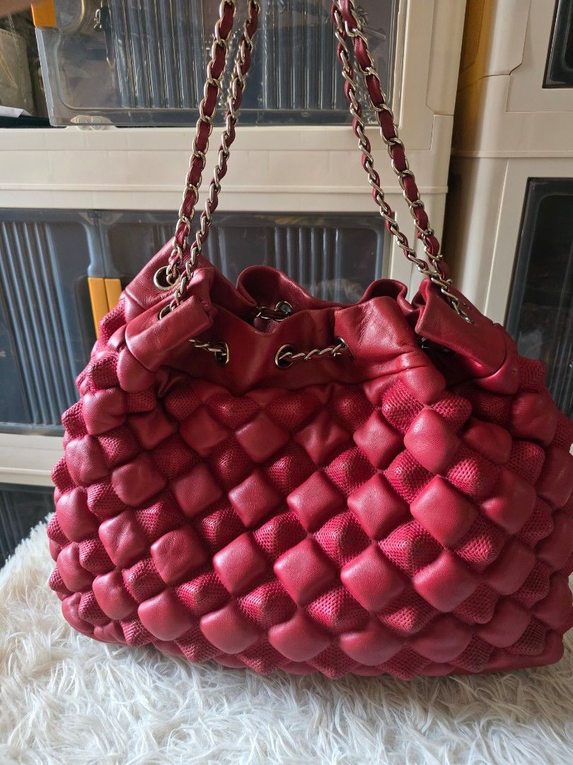 Chanel Quilted Red Leather Handbag with Chain Strap (Category: Shoulder Bags) located in Lemery. Submitted by venus23 (Listing ID 1470371751, Image 2). Description: - red leather handbag with a chic puffy quilted texture - Silver chain straps threaded with matching red leather - Iconic CC logo charm hanging from the top - Gold fabric interior lining featuring Chanel lettering throughout - Practical zippered inner pocket, interior brand tag, and a