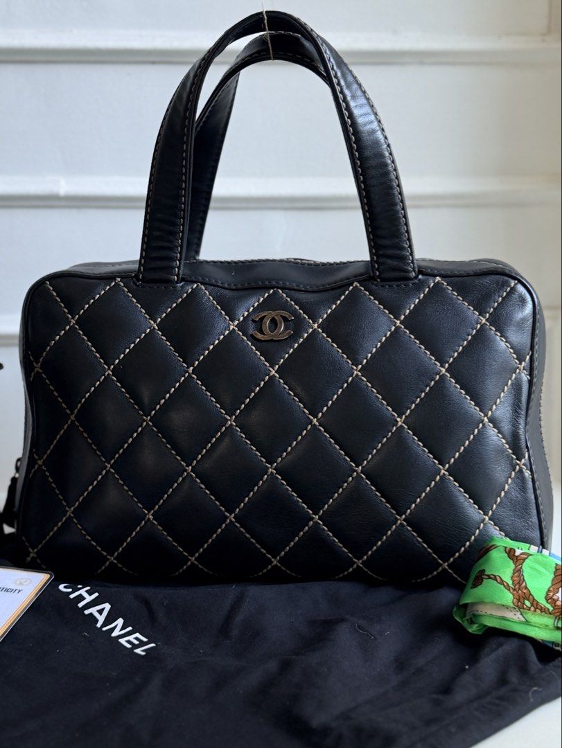 CHANEL Wild Stitch Bowler Bag, Black (Category: Tote Bags) located in Quezon City. Submitted by official_kiyowo.vintage (Listing ID 1470425700, Image 3). Description: - Authentic black leather Chanel tote with striking contrast stitching - Features iconic silver interlocking CC logo on the front and back slip pocket - Equipped with comfortable double top handles for easy everyday wear - Includes black dust bag, matching black cosmetic pouch, and 