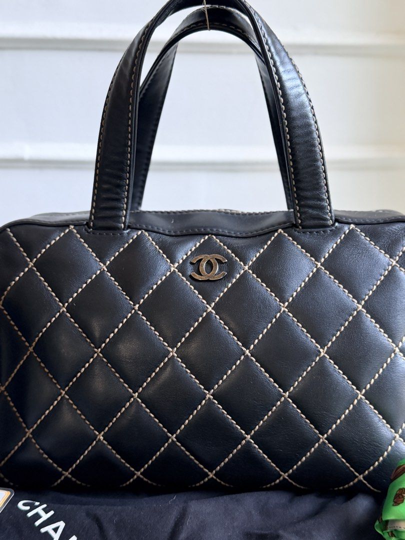 CHANEL Wild Stitch Bowler Bag, Black (Category: Tote Bags) located in Quezon City. Submitted by official_kiyowo.vintage (Listing ID 1470425700, Image 2). Description: - Authentic black leather Chanel tote with striking contrast stitching - Features iconic silver interlocking CC logo on the front and back slip pocket - Equipped with comfortable double top handles for easy everyday wear - Includes black dust bag, matching black cosmetic pouch, and 