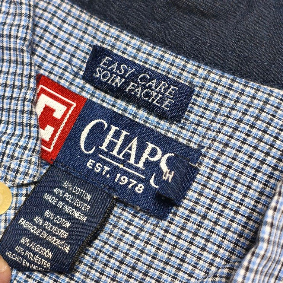 Chaps Men Blue Checkered Short Sleeve Button Down Shirt (Category: Tshirts & Polo Shirts ) located in Meycauayan. Submitted by thrifting_gorilla (Listing ID 1470528092, Image 3). Description: Chaps Men Blue Checkered Short Sleeve Button Down Shirt - Brand: Chaps - Style: Short sleeve button-down shirt - Pattern: Blue and white checkered - Material: Easy care 60% cotton, 40% polyester blend - Details: Classic button-down collar with accents, chest