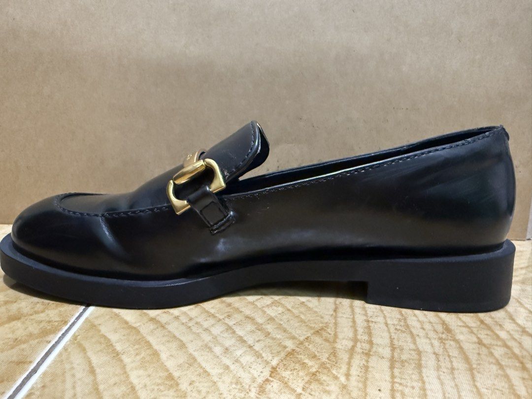 Charles & Keith Black Loafers with Gold Hardware (Category: Loafers) located in Muntinlupa City. Submitted by sellesayo08 (Listing ID 1470357310, Image 3). Description: Classic black loafers from Charles & Keith. Gold-tone metal hardware across the front strap. Chunky platform sole with a small heel. Slip-on design. Minimal creasing on the leather upper from normal wear. Clean interior lining. Solid construction, sturdy rubber soles..