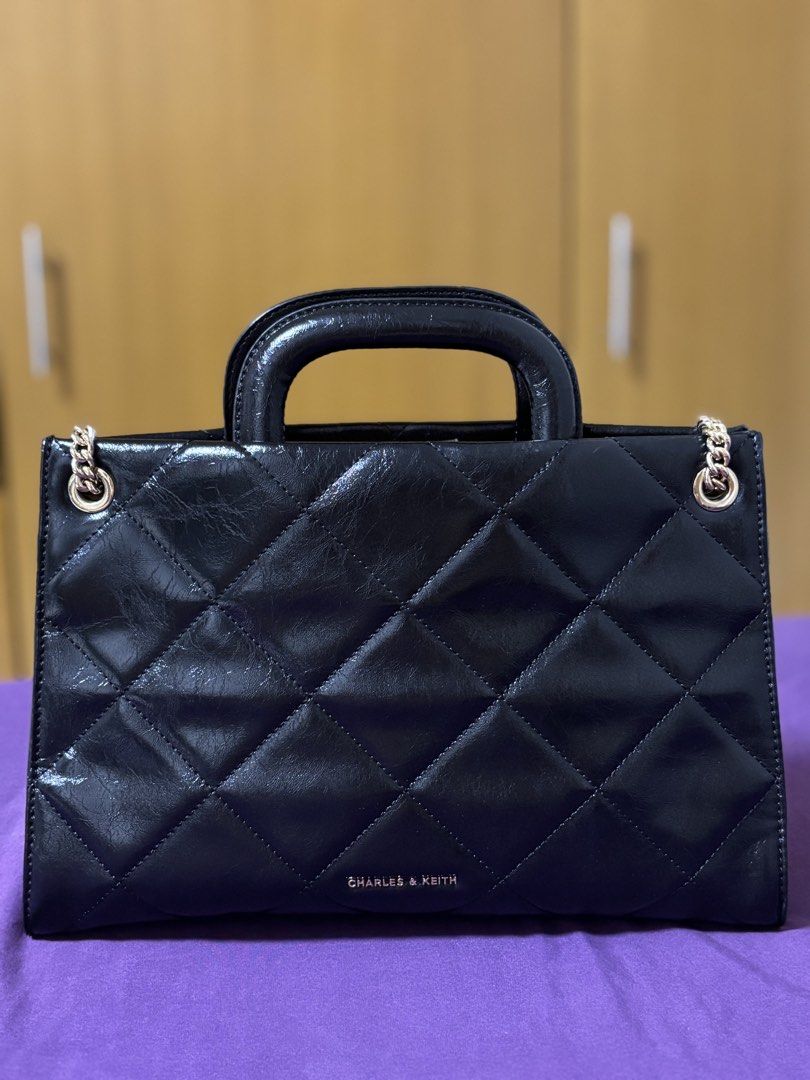 Charles & Keith Black Quilted Chain Shoulder Bag (Category: Shoulder Bags) located in Taguig. Submitted by karlas.closet (Listing ID 1470504233, Image 3). Description: FOR SALE - Charles & Keith classic black quilted bag - Double handles with sliding gold chain strap - Great condition. No flaw. - Original price at the time of purchase - Php 6,000. - Selling for only Php 1,000!.