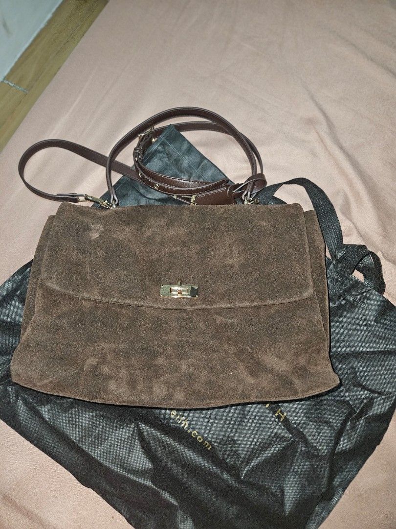 Charles & Keith Suede Brown handbag (w/ sling) (Category: Luxury Bags & Wallets) located in Quezon City. Submitted by maraclara007 (Listing ID 1470455410, Image 1). Description: - Brand: Charles & Keith - Material: Rich brown suede - Hardware: Gold-tone with turn-lock closure - Details: Decorative key charms on the strap - Strap: Includes long shoulder strap - Inclusions: Original dust bag - Condition: Clean interior, well-kept exterior - Feature