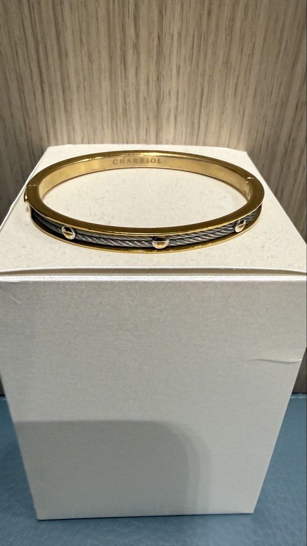 Charriol Cable Bangle Bracelet Gold & Silver Tone (Category: Bracelets) located in Las Pinas. Submitted by happydragon_07d654 (Listing ID 1470379190, Image 1). Description: - Authentic Charriol bangle bracelet - Two-tone gold and silver metal finishes - Signature twisted cable wire band with stud accents - Convenient side hinged closure for easy wear - Clear brand logo stamp on the inner band No box. Selling 25,000 for 2 items - Clean, elegant fi