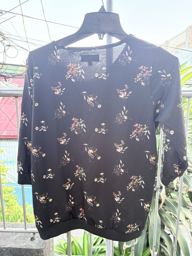 Cherokee Black Floral Blouse (Category: Blouses) located in Cavite. Submitted by earthread (Listing ID 1470452841, Image 2). Description: - Brand: Cherokee - Size: Medium - Design: Black with all-over small floral print - Features: Rounded neckline, three-quarter sleeves, ribbed cuffs and hem - Material: Lightweight and smooth - Condition: Excellent, clean with no stains or damage - Versatility: Perfect for casual wear or the office.