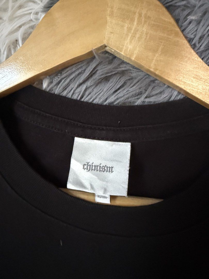 Chinistm Black Graphic Tee Size S (Category: Tshirts & Polo Shirts ) located in Manila. Submitted by keepercollection (Listing ID 1470376833, Image 3). Description: - Brand: Chinistm - Color: Black short sleeve t-shirt - Design: White gothic CH logo printed on the chest - Size: S (Marked 165/88A) - Measurements: ~22" pit to pit, ~29" total length - Material: Heavyweight cotton - Condition: Clean and ready to wear.
