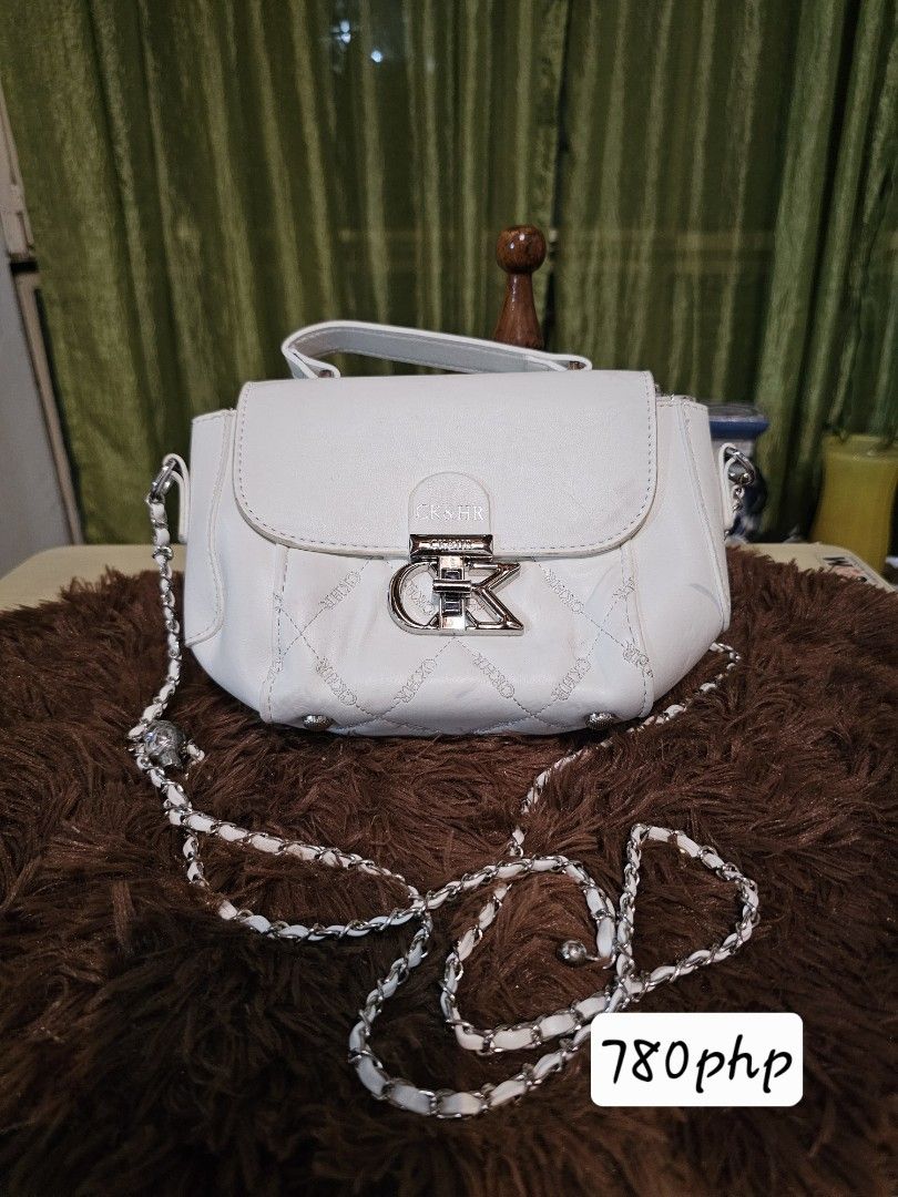 CK Pink Shoulder Bag with Plush Charm (Category: Shoulder Bags) located in Pagadian. Submitted by buyhere888 (Listing ID 1470473794, Image 2). Description: - Authentic pink shoulder bag with structured shape - Features eye-catching metallic CK logo hardware on the front flap - Elegant chain strap for versatile wear - Textured pink material for a chic look - Comes with an adorable matching pink plush bunny charm.