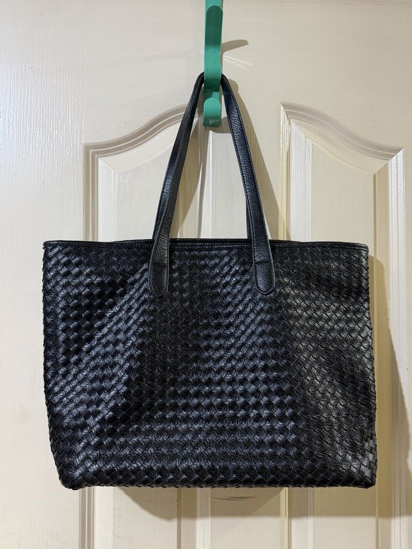 Classic Woven Leather Tote in Black (Category: Tote Bags) located in Pasig City. Submitted by paolasoriano_wind (Listing ID 1470451610, Image 1). Description: Lightly used. No damages except for some signs of use on handle (not easily noticeable / not an issue). Overall EXCELLENT CONDITION. Preloved but well taken-cared of. Faux leather. Does not look cheap. Size: Large (can fit a 13” MacBook and other items). With zipper and lining. Sturdy, spac