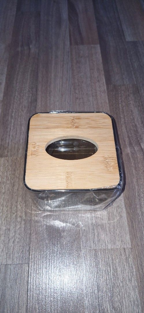Clear and Wooden Tissue Box Holder (Category: Storage Boxes & Baskets) located in San Juan City. Submitted by mamba_collectibles (Listing ID 1470554085, Image 2). Description: - Modern & Minimalist: Clear plastic body with a stylish bamboo wooden top lid that fits any tabletop or desk. - Easy Refilling: Removable wooden lid allows for quick and simple tissue refills. - Perfect Fit: Designed to hold standard tissue sizes securely. - Versatile Use: