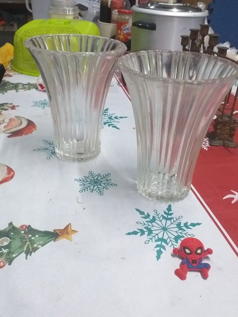 Clear Glass Fluted Flower Vases Set (Category: Vases & Decorative Bowls) located in Manila. Submitted by wisegem-231b (Listing ID 1470398808, Image 3). Description: - Set of 2 matching clear glass vases - Elegant fluted vertical ribbing with a flared top rim - Sturdy flat bases for stability - Versatile clear glass complements any flowers or room decor - Clean inside and out, ready for use.