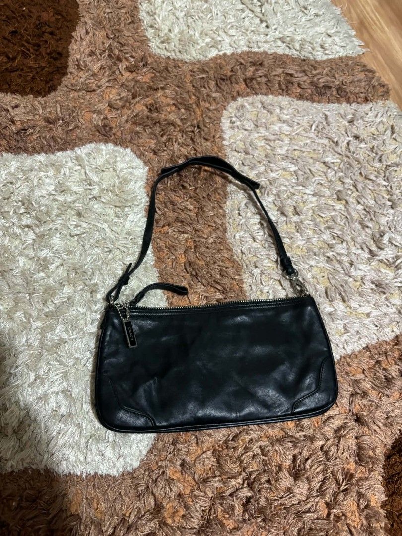 Coach Black Leather Shoulder Bag (Category: Luxury Bags & Wallets) located in Daet. Submitted by jemotovlog28 (Listing ID 1470399013, Image 2). Description: - Brand: Coach - Material: Genuine black leather - Style: Slim silhouette shoulder bag with single strap - Closure: Secure top zipper - Details: Includes iconic metal Coach hangtag - Interior: Fabric-lined with official leather creed patch and serial number (J1K-8324) - Fit: Compact and light