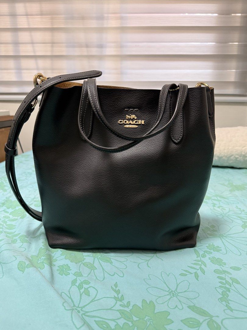 Coach Black Pebbled Leather Tote Bag (Category: Luxury Bags & Wallets) located in Manila. Submitted by abiespreloved (Listing ID 1470378991, Image 3). Description: - Brand: Coach - Material: Premium black pebbled leather - Hardware: Elegant gold-tone - Straps: Double top handles + adjustable, detachable shoulder strap - Interior: Spacious tan lining with a secure middle zip compartment and snap closure pocket - Condition: Like New used 3 times Gu