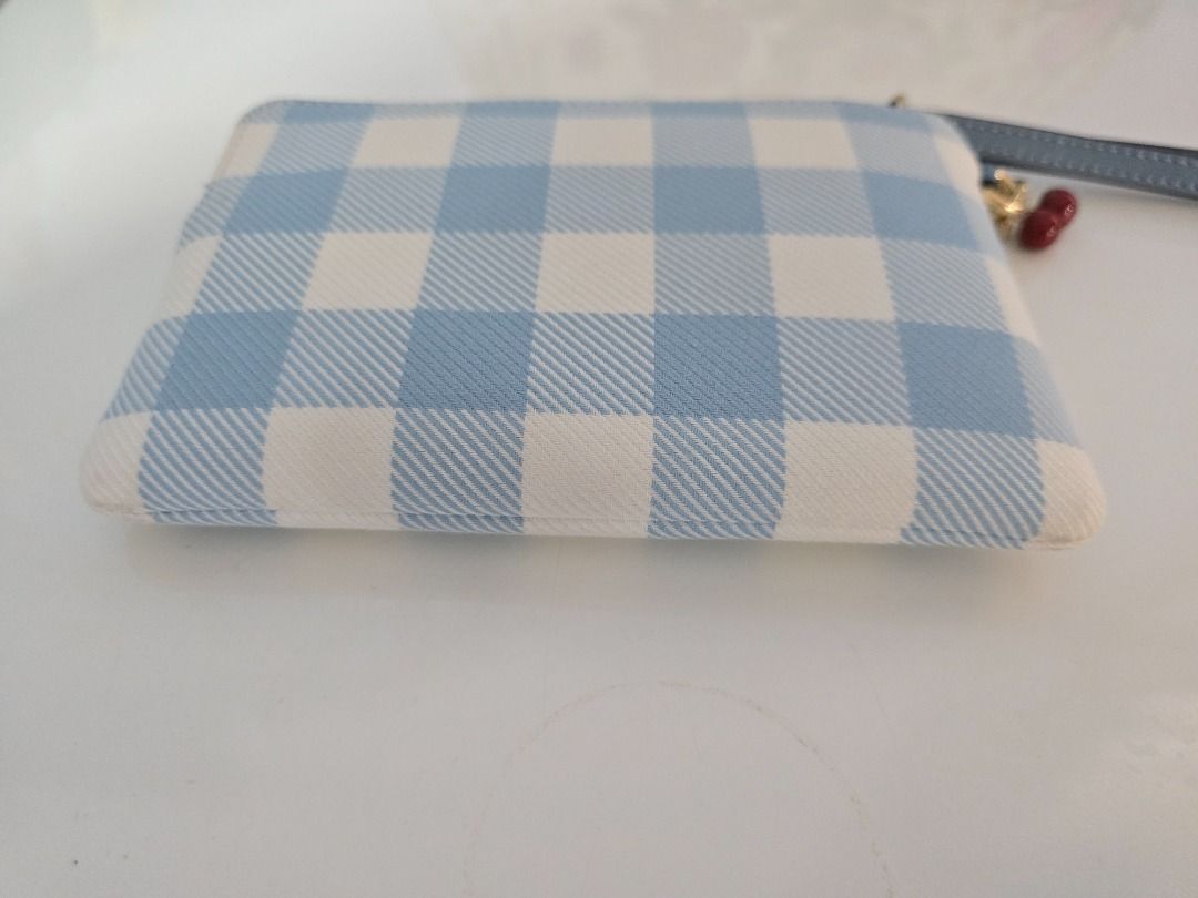 Coach Blue Gingham Print Wristlet Pouch with Cherry Charm (Category: Purses & Pouches) located in Quezon City. Submitted by purinthriftshop (Listing ID 1470364396, Image 3). Description: - Brand: Coach - Design: Blue and white gingham print canvas with gold-tone hardware and front logo - Strap: Blue leather wrist strap - Accent: Cute cherry charm on the zipper pull - Closure: Secure zip top - Condition: Clean inside and out, from a smoke-free hom