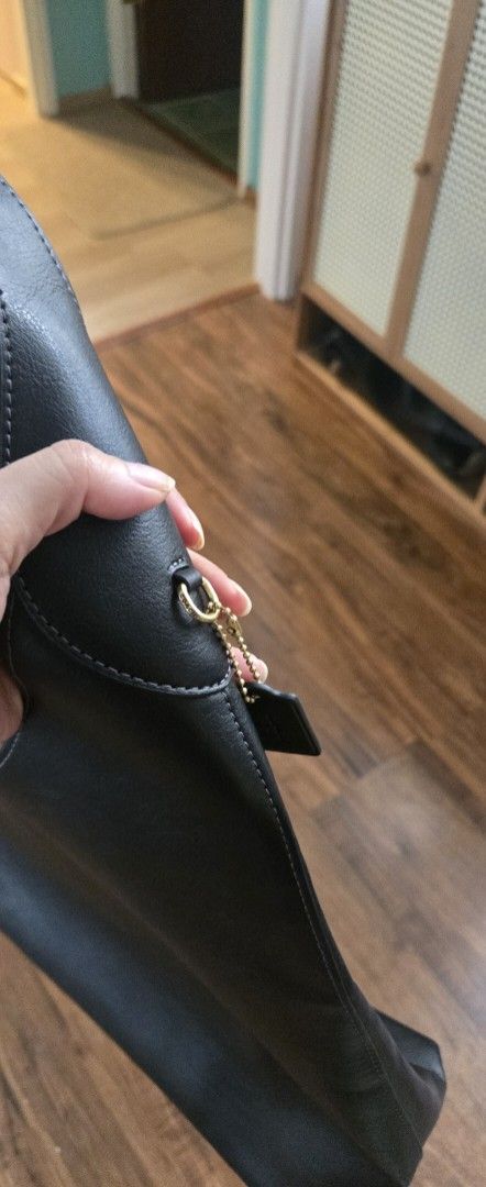 Coach Bootklyn Hobo Leather Shoulder Bag (Category: Luxury Bags & Wallets) located in Quezon City. Submitted by PreLovedByMrsAL (Listing ID 1470379135, Image 2). Description: - Brand: Coach - Material: Soft black leather with matching hardware - Design: Slouchy shoulder bag with a thin, comfortable strap - Details: Gold front lettering and signature hangtag - Condition: Clean inside and out with minimal wear - Capacity: Spacious interior for all 