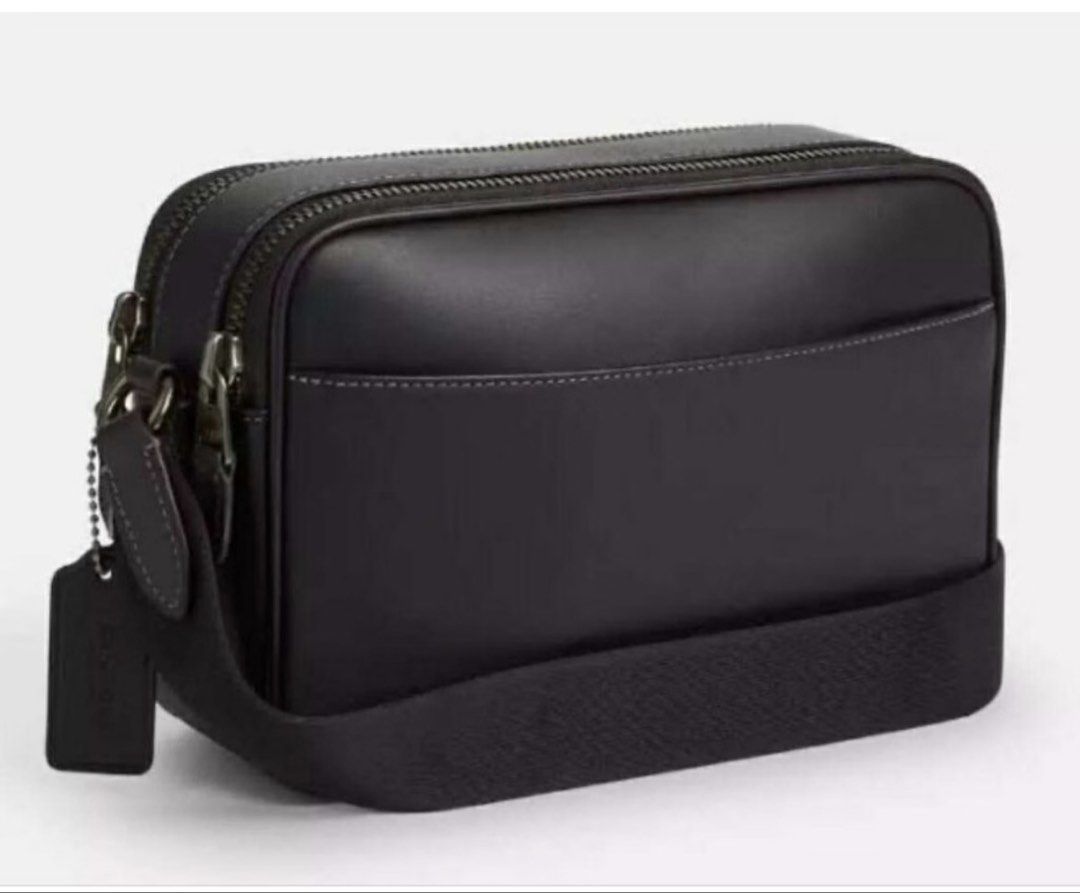 Coach Graham Crossbody Bag Black (Category: Cross-body Bags) located in Cabanatuan. Submitted by paul04_moon (Listing ID 1470397813, Image 2). Description: - Authentic Coach Graham crossbody bag in classic black leather - Sleek design featuring dual zipped compartments - Comfortable adjustable strap for easy wear - Subtle debossed Coach logo on the front - Includes original tag with retail price - Perfect everyday carryall for your daily essentia