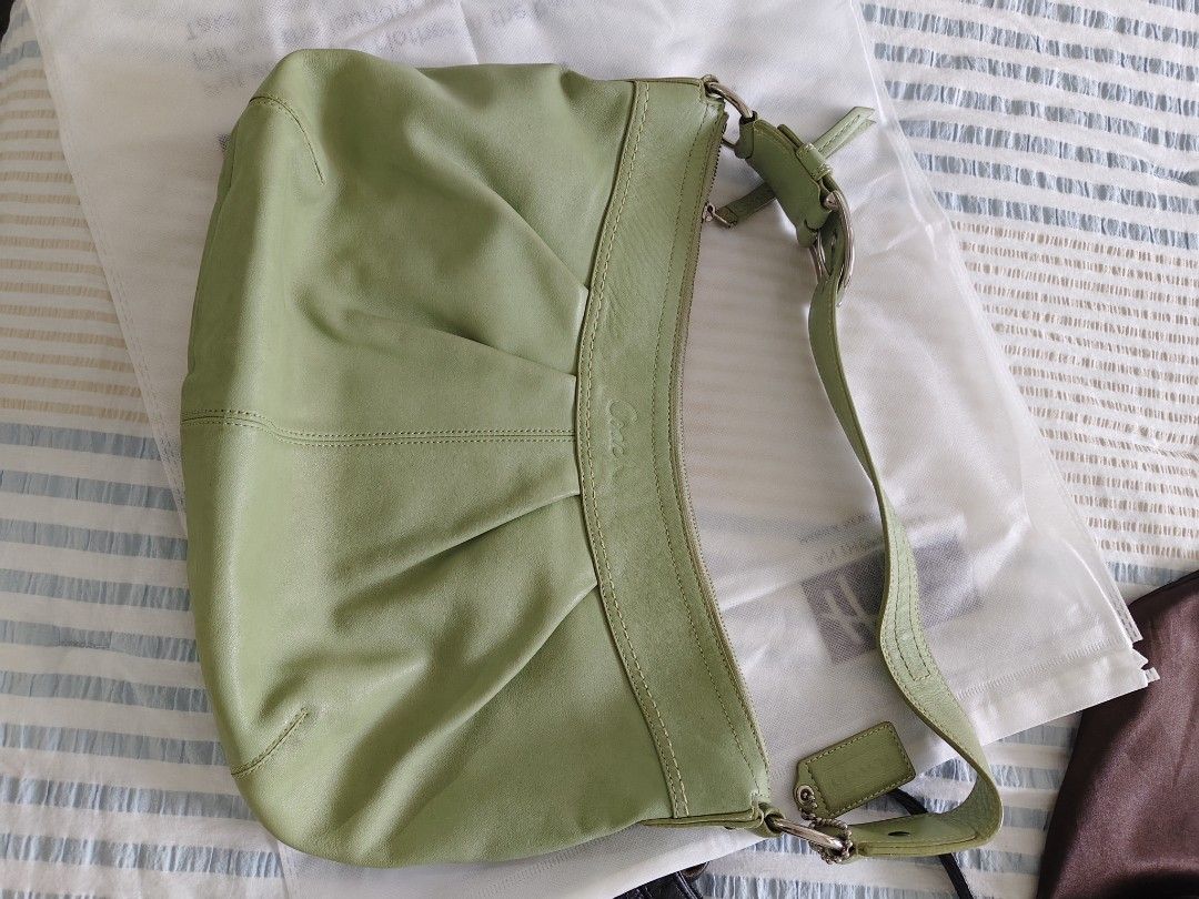 Coach Green Leather Shoulder Bag (Category: Luxury Bags & Wallets) located in Pasig City. Submitted by janelchoo (Listing ID 1470423170, Image 1). Description: - Brand: Coach - Color: Sage green - Material: Genuine soft leather - Closure: Zip-top - Design: Gathered pleat detailing on the front with a slouchy shape - Strap: Adjustable buckle strap - Inclusions: Original dust bag and hanging leather tag.
