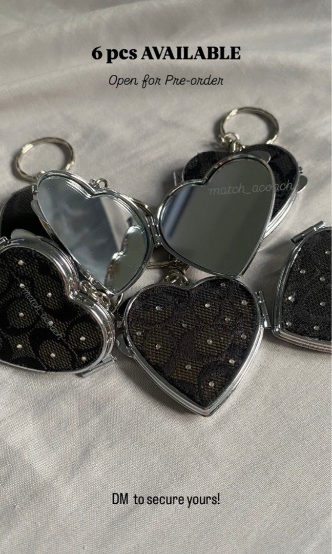 Coach Heart Mirror Locket Keychain (Category: Luxury Accessories) located in Luisiana. Submitted by matchacoach (Listing ID 1470452666, Image 1). Description: Coach Heart Mirror Locket Keychain is the perfect blend of classy and cute. Made using original Coach canvas (f70283) - Hand-placed rhinestone embellishments - Opens up into a functional compact mirror - Crafted entirely by hand with love Give your keys or bags the glow-up they deserve. 6 p