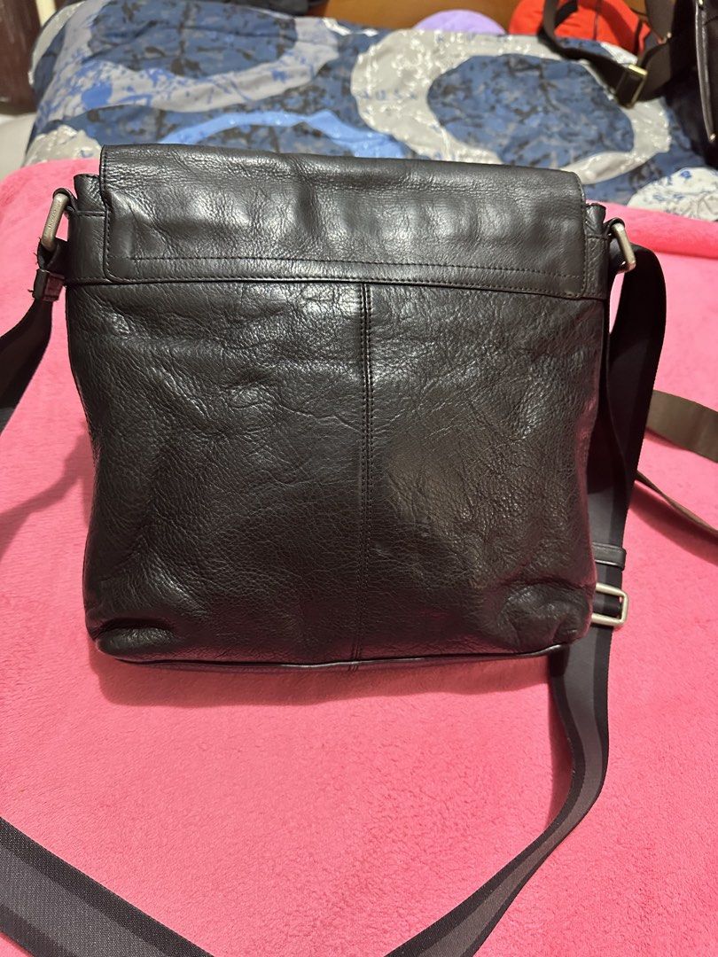 Coach Leather Messenger Crossbody Bag (Category: Luxury Bags & Wallets) located in Quezon City. Submitted by pongoy (Listing ID 1470392117, Image 2). Description: - Authentic Coach messenger bag in classic black - Crafted from genuine pebble leather with fabric lining - Secure flap closure featuring a subtle debossed logo - Adjustable fabric strap for comfortable shoulder or crossbody wear - Convenient exterior zip pocket located right under the 