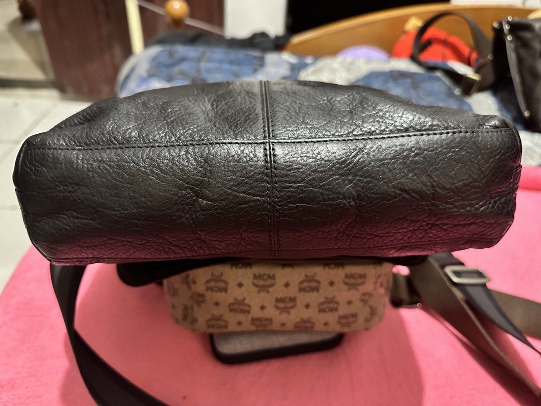 Coach Leather Messenger Crossbody Bag (Category: Luxury Bags & Wallets) located in Quezon City. Submitted by pongoy (Listing ID 1470392117, Image 3). Description: - Authentic Coach messenger bag in classic black - Crafted from genuine pebble leather with fabric lining - Secure flap closure featuring a subtle debossed logo - Adjustable fabric strap for comfortable shoulder or crossbody wear - Convenient exterior zip pocket located right under the 