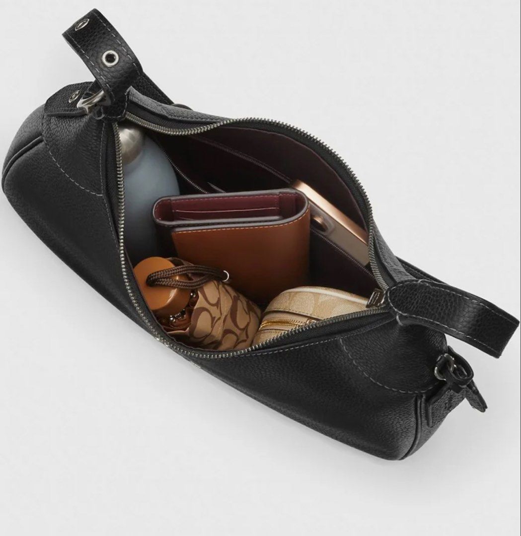 Coach Lux Pebble Ella Shoulder Bag Black (Category: Luxury Bags & Wallets) located in Cabanatuan. Submitted by paul04_moon (Listing ID 1470395978, Image 3). Description: - Authentic Coach Lux Pebble Ella shoulder bag in classic black leather - Secure zip top closure with a spacious interior that fits a wallet, phone, and water bottle - Adjustable strap featuring stylish silver-tone hardware and buckle detail - Perfect everyday luxury bag for work