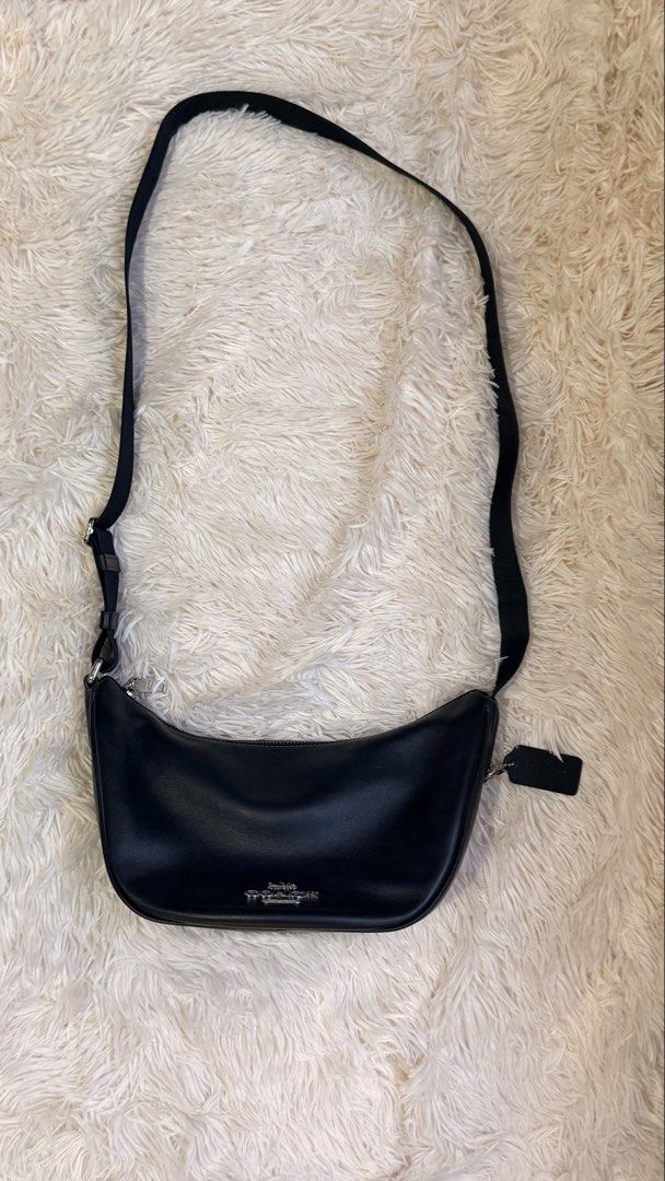 Coach Pace Shoulder Bag (Category: Luxury Bags & Wallets) located in Pasay City. Submitted by erinsclosetph (Listing ID 1470361007, Image 2). Description: Coach Pace Black Shoulder Bag Curved crescent hobo silhouette, silver-tone hardware, top zip closure with an adjustable fabric shoulder strap. Very good condition. Flaws: slight tarnishing on hardware and hairline scratches on the leather Measurements: 15 × 29 × 12 cm..