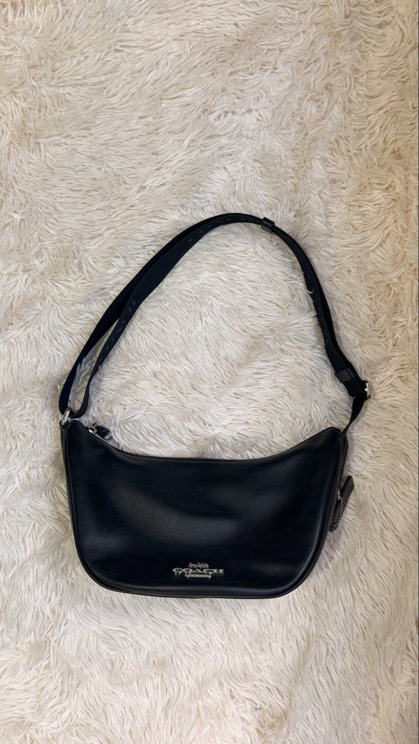 Coach Pace Shoulder Bag (Category: Luxury Bags & Wallets) located in Pasay City. Submitted by erinsclosetph (Listing ID 1470361007, Image 1). Description: Coach Pace Black Shoulder Bag Curved crescent hobo silhouette, silver-tone hardware, top zip closure with an adjustable fabric shoulder strap. Very good condition. Flaws: slight tarnishing on hardware and hairline scratches on the leather Measurements: 15 × 29 × 12 cm..