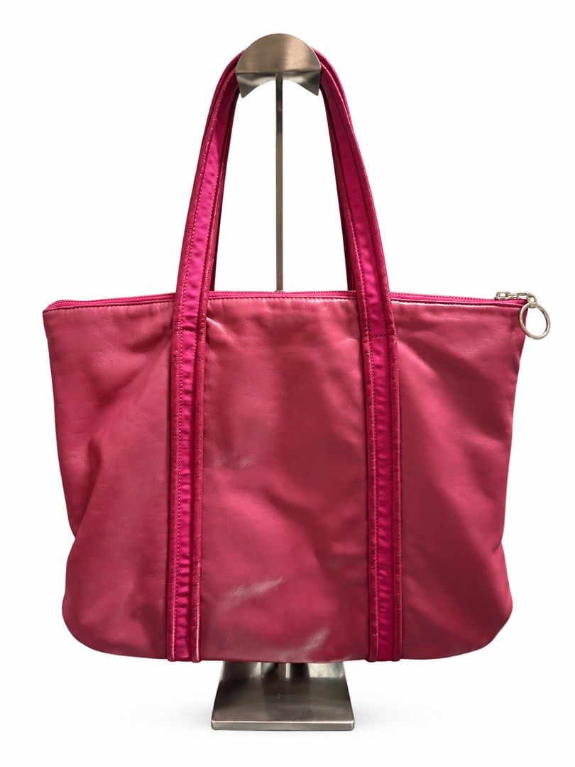 Coach Pink Leather Tote Bag (Category: Luxury Bags & Wallets) located in Tangub. Submitted by laurbepena33002 (Listing ID 1470354599, Image 2). Description: - Authentic Coach leather shoulder bag in a bold mettalic bright pink - Secure top zipper closure with 2 exterior zipped pockets and ring pulls - Vibrant purple satin interior lining with multiple slip pockets and a zip pocket - Shiny silver hardware details and metallic Coach creed patch - R