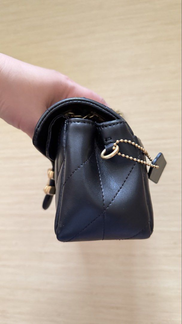 Coach Quilted Pillow Tabby Shoulder Bag Black (Category: Cross-body Bags) located in Caloocan City. Submitted by thriftshop_ph (Listing ID 1470430303, Image 3). Description: - Authentic Coach black quilted leather shoulder bag - Elegant gold-tone hardware with signature C clasp - Versatile chain strap and secure flap closure - Clean fabric-lined interior with multiple compartments - Complete with matching leather logo hangtag.