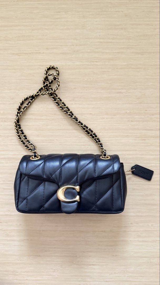Coach Quilted Pillow Tabby Shoulder Bag Black (Category: Cross-body Bags) located in Caloocan City. Submitted by thriftshop_ph (Listing ID 1470430303, Image 1). Description: - Authentic Coach black quilted leather shoulder bag - Elegant gold-tone hardware with signature C clasp - Versatile chain strap and secure flap closure - Clean fabric-lined interior with multiple compartments - Complete with matching leather logo hangtag.