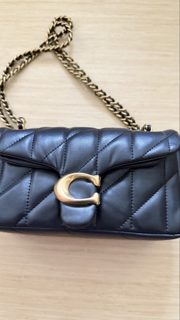 Coach Quilted Pillow Tabby Shoulder Bag Black (Category: Cross-body Bags) located in Caloocan City. Submitted by thriftshop_ph (Listing ID 1470430303, Image 2). Description: - Authentic Coach black quilted leather shoulder bag - Elegant gold-tone hardware with signature C clasp - Versatile chain strap and secure flap closure - Clean fabric-lined interior with multiple compartments - Complete with matching leather logo hangtag.