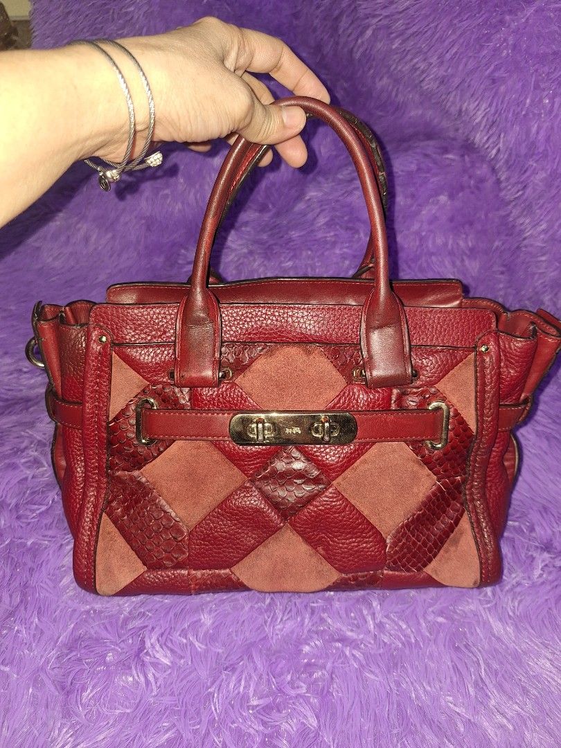 Coach Red Patchwork Leather and Suede Handbag (Category: Luxury Bags & Wallets) located in Quezon City. Submitted by cloudymay (Listing ID 1470551370, Image 1). Description: Red Coach handbag crafted from mixed leather, suede, and embossed snakeskin patches. Structured silhouette with dual top handles and gold-tone hardware. Front turnlock closure secures the flap. Side strap with D-ring accent. Rich burgundy shade throughout. Spacious interior c