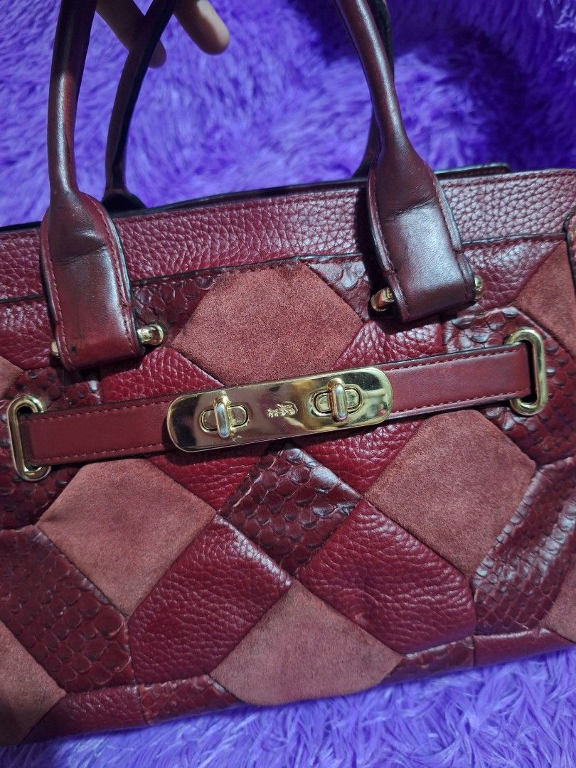 Coach Red Patchwork Leather and Suede Handbag (Category: Luxury Bags & Wallets) located in Quezon City. Submitted by cloudymay (Listing ID 1470551370, Image 3). Description: Red Coach handbag crafted from mixed leather, suede, and embossed snakeskin patches. Structured silhouette with dual top handles and gold-tone hardware. Front turnlock closure secures the flap. Side strap with D-ring accent. Rich burgundy shade throughout. Spacious interior c