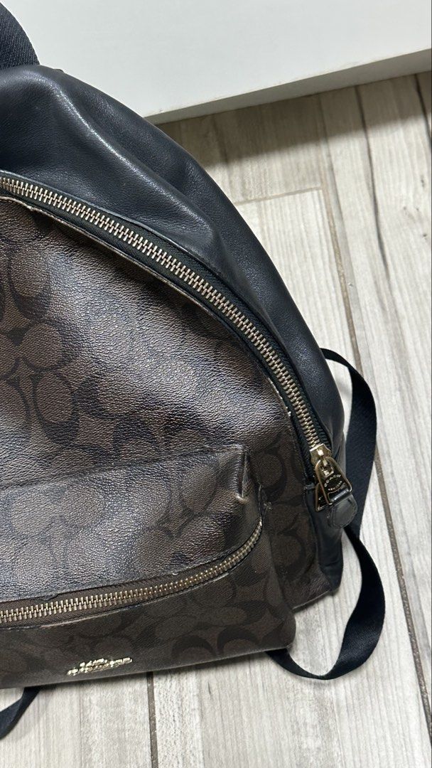 Coach Signature Canvas Leather Backpack Dark Brown Black (Category: Backpacks) located in Quezon City. Submitted by rccola__ (Listing ID 1470375993, Image 3). Description: - Brand: Coach - Material: Signature monogram canvas with black leather trim - Color: Dark brown with black and gold-tone hardware - Compartments: Roomy main compartment with zip closure and front zip pocket - Details: Coach New York logo stamp, dual shoulder straps, top grab h