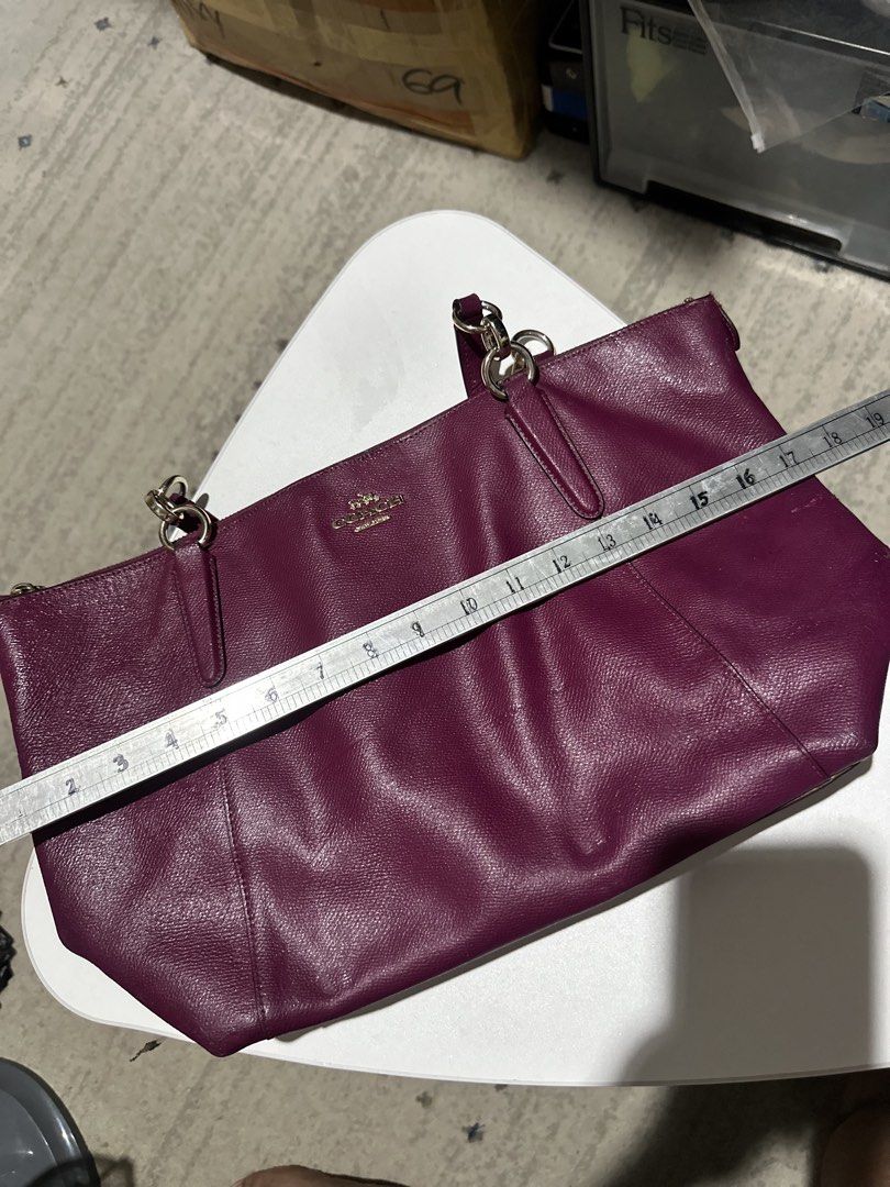 Coach Tote Bag Berry Purple Leather (Category: Luxury Bags & Wallets) located in Daet. Submitted by thrifthings2018 (Listing ID 1470450359, Image 2). Description: - Brand: Coach - Material: Berry purple pebble leather with gold hardware - Closure: Zip top - Straps: Double shoulder straps - Dimensions: Approx. 16" wide x 11" tall - Condition/Shape: Clean interior, structured shape - Features: Great everyday size for work or school; easily fits lap